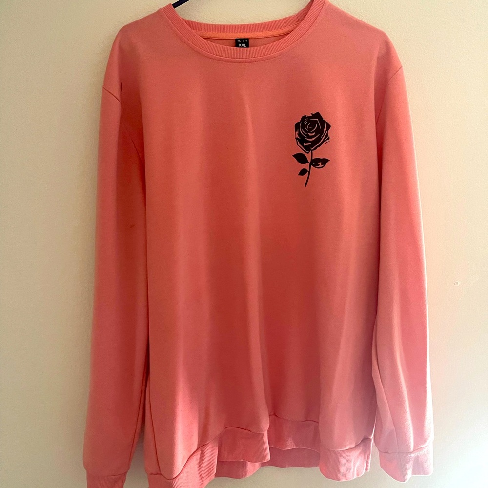 Selling Pink long-sleeve with a black rose on top.